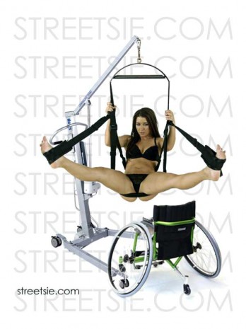 Sexy wheelchair lover legs spread in love swing suspended by personal patient hoist